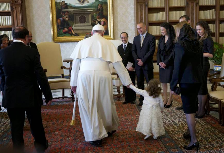Pope Francis led by a child